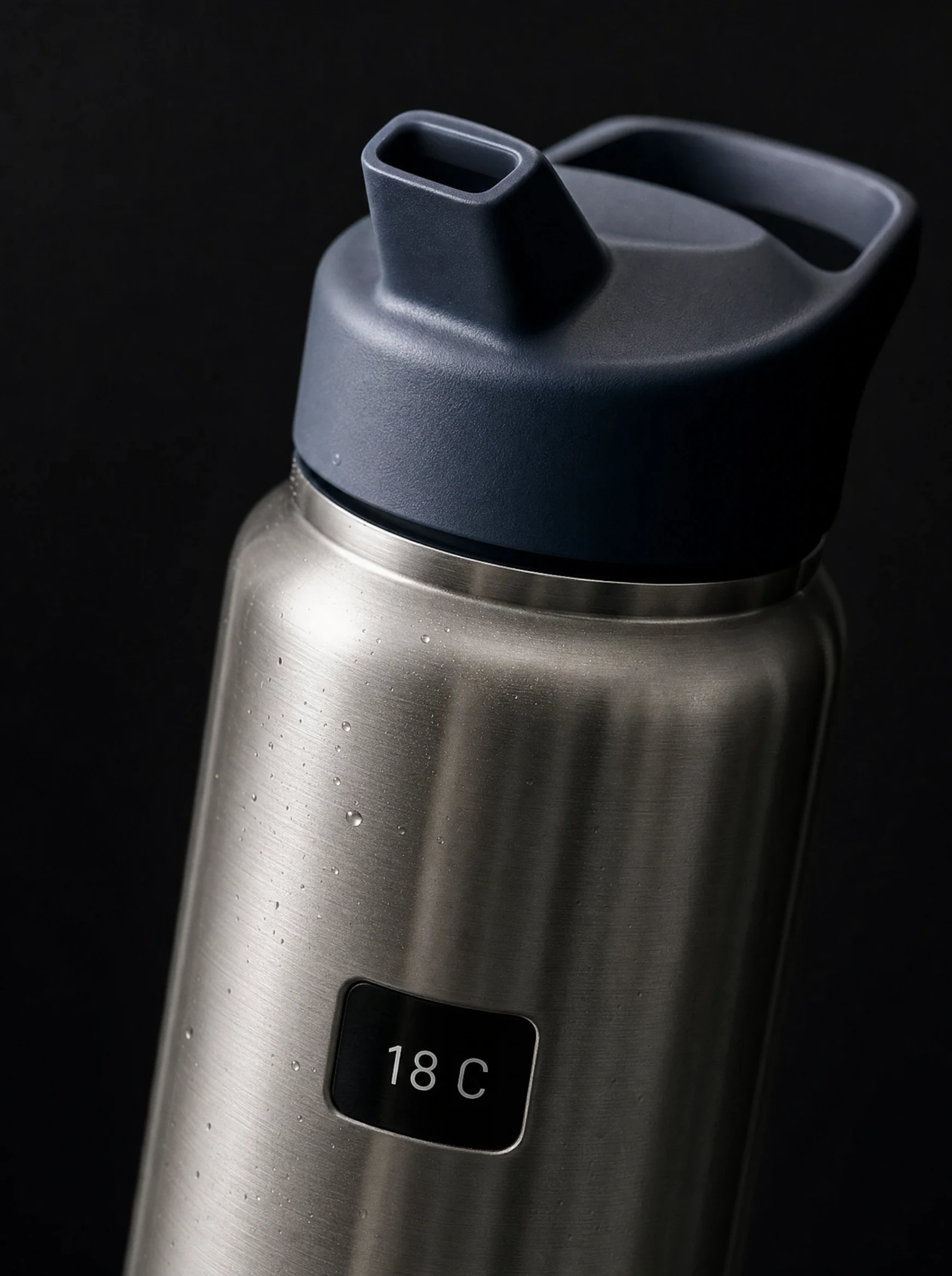 Macro concept photograph of the brushed steel shoulder and drinking lid